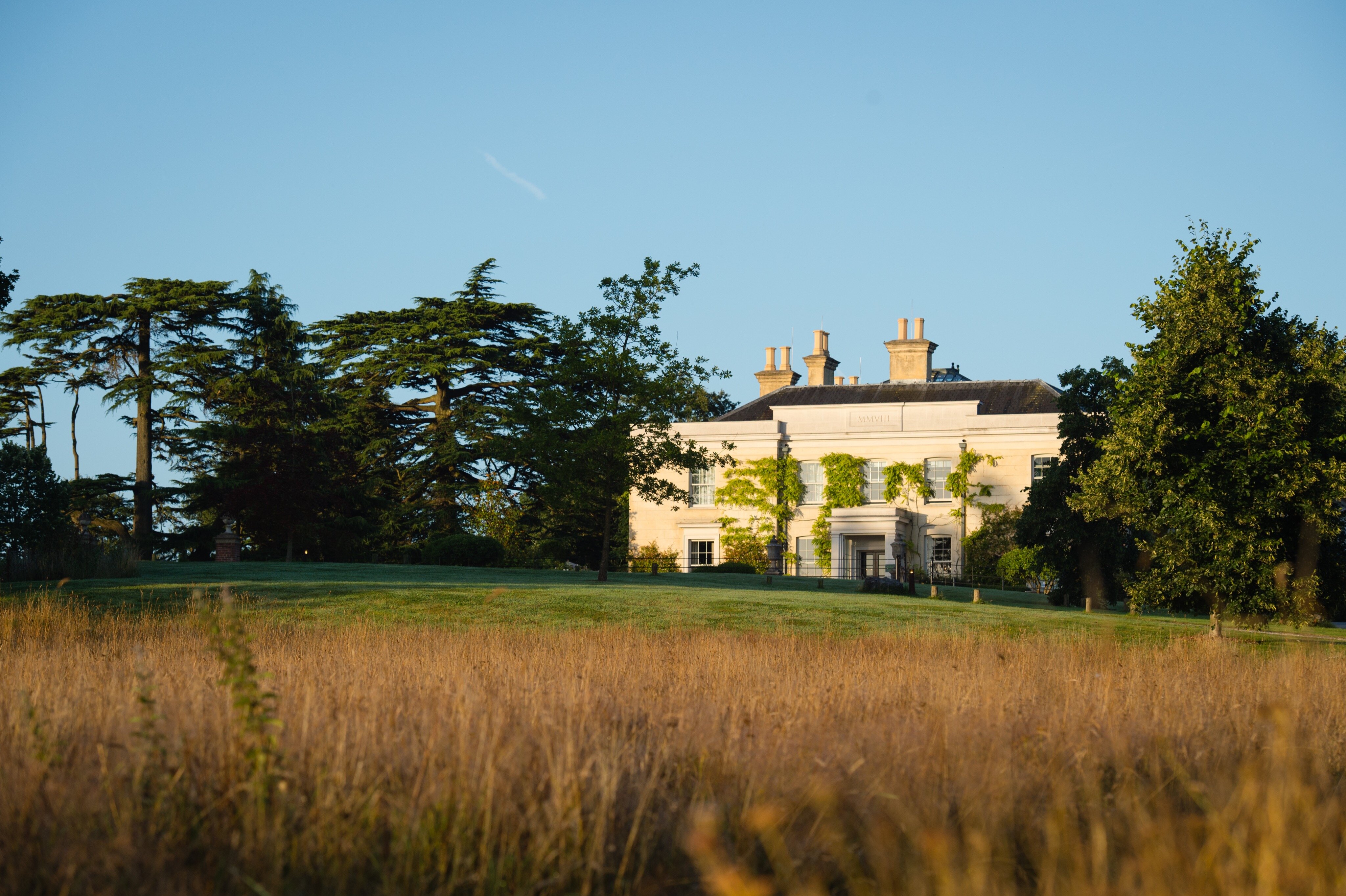 Limewood Hotel at sunrise through long grass